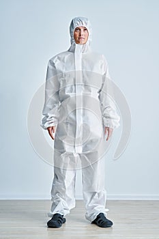 Woman in bio-hazard suit on white background.