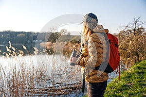 Woman biologist is watching birds with binoculars