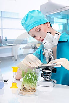 Woman biologist working with microscope