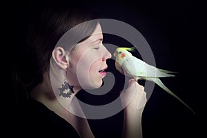 Woman and bird on black background