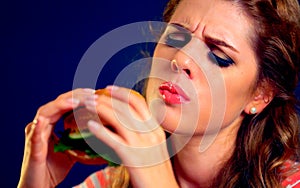 Woman bite hamburger fast food.