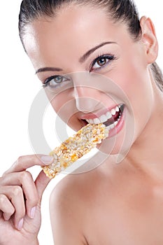 Woman biting cereal bar