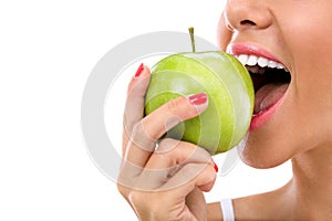 Woman biting a green apple