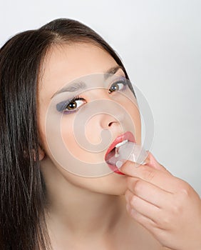 Woman biting an ice cube