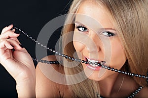 woman biting pearls