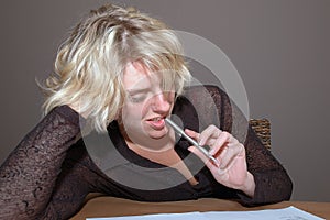 Woman biting pen