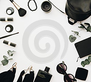 Woman black accessories grouped around empty space for text. photo
