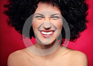 Woman with black afro hairstyle smiling