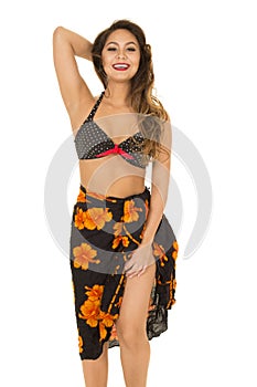 Woman in black bikini top and sarong around waist big smile show