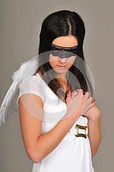 Woman with black blindfold and angel wings