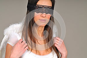 Woman with black blindfold and angel wings