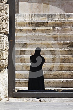 Woman in black burka in an arabic land