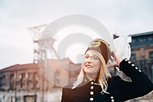 Woman in black coal miner foreman gala uniform with white feather on hat.