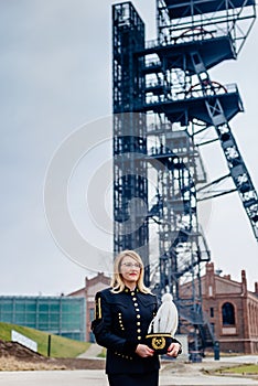 Woman in black coal miner foreman gala uniform.