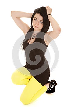 Woman black dress yellow legs kneel