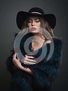 Woman in black hat and fur on a dark background studo shot photo photo