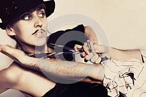 Woman in a black hat and painted mustache