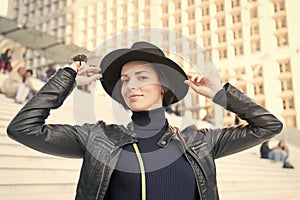 Woman in black hat smile on stairs in paris, france, fashion. Sensual woman with brunette hair, hairstyle. Fashion