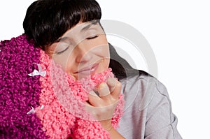 Woman with black long hair and closed her eyes to snuggle to warm plaid isolated on white background