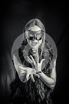 Woman in black mask performing