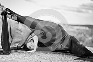 Woman in black overalls dancing with flying fabric