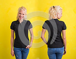 Woman in black polo T-shirt on yellow background