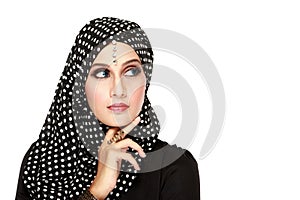 Woman with black scarf looking up to copy space