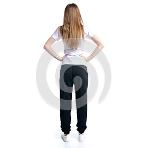 Woman in black sweatpants and white t-shirt standing