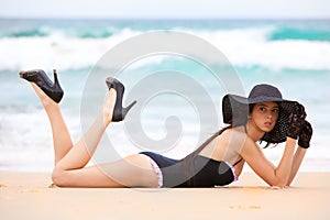 Woman in Black Swimsuit and Accessories Lying on t