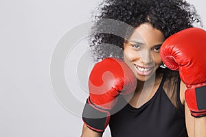 Woman in black tank top with red boxing gloves