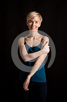 Woman in black tank top suffering from vitiligo disorder