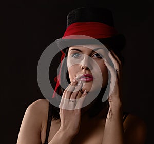 Woman in black tophat with red shawl