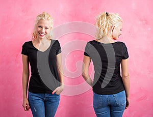 Woman in black V-neck T-shirt on pink background photo