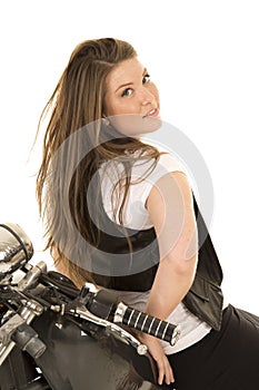 Woman black vest motorcycle sit backwards look over shoulder