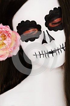 Woman with black and white face art on her face