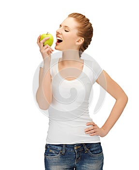 Woman in blank t-shirt eating green apple