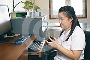 Woman with blindness disability using smart phone with voice accessibility for persons with disabilities in workplace with photo