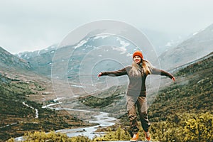 Woman bliss emotional raised hands foggy mountains photo