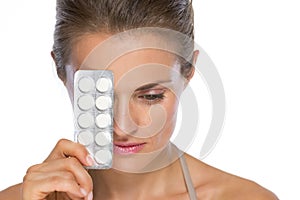 Woman with blistering package of pills