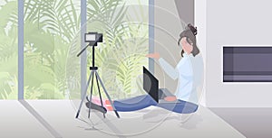 Woman blogger recording video blog during coronavirus quarantine live streaming blogging concept