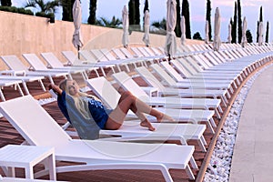 woman with blond hair in elegant bikini posing near luxurio