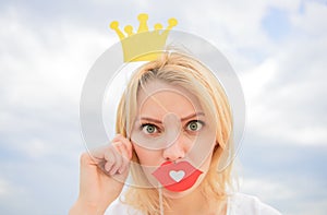 Woman blonde hair hold cardboard tiara or crown and red lips symbol of love sky background. Lady princess posing