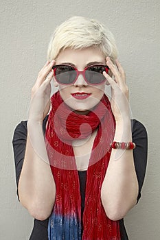 Woman blonde in red scarf, sunglasses. Fashion haircut, accessories.