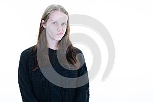 Woman blonde young pouts lips grimacing with her mouth aside copy space on white background