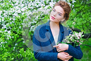 Woman in blooming spring garden