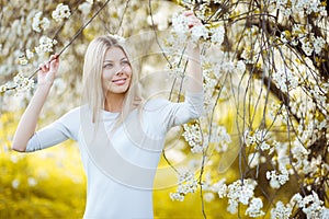 Woman in blooming tree in spring