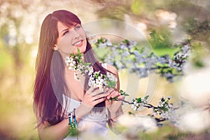 Woman in blooming trees in spring