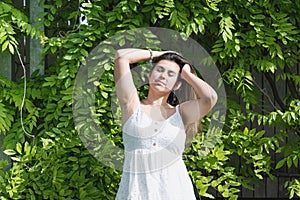 woman in a blooming wisteria garden