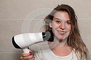 Woman blow drying her hair