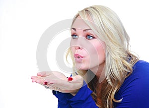 Woman blowing air over hands.